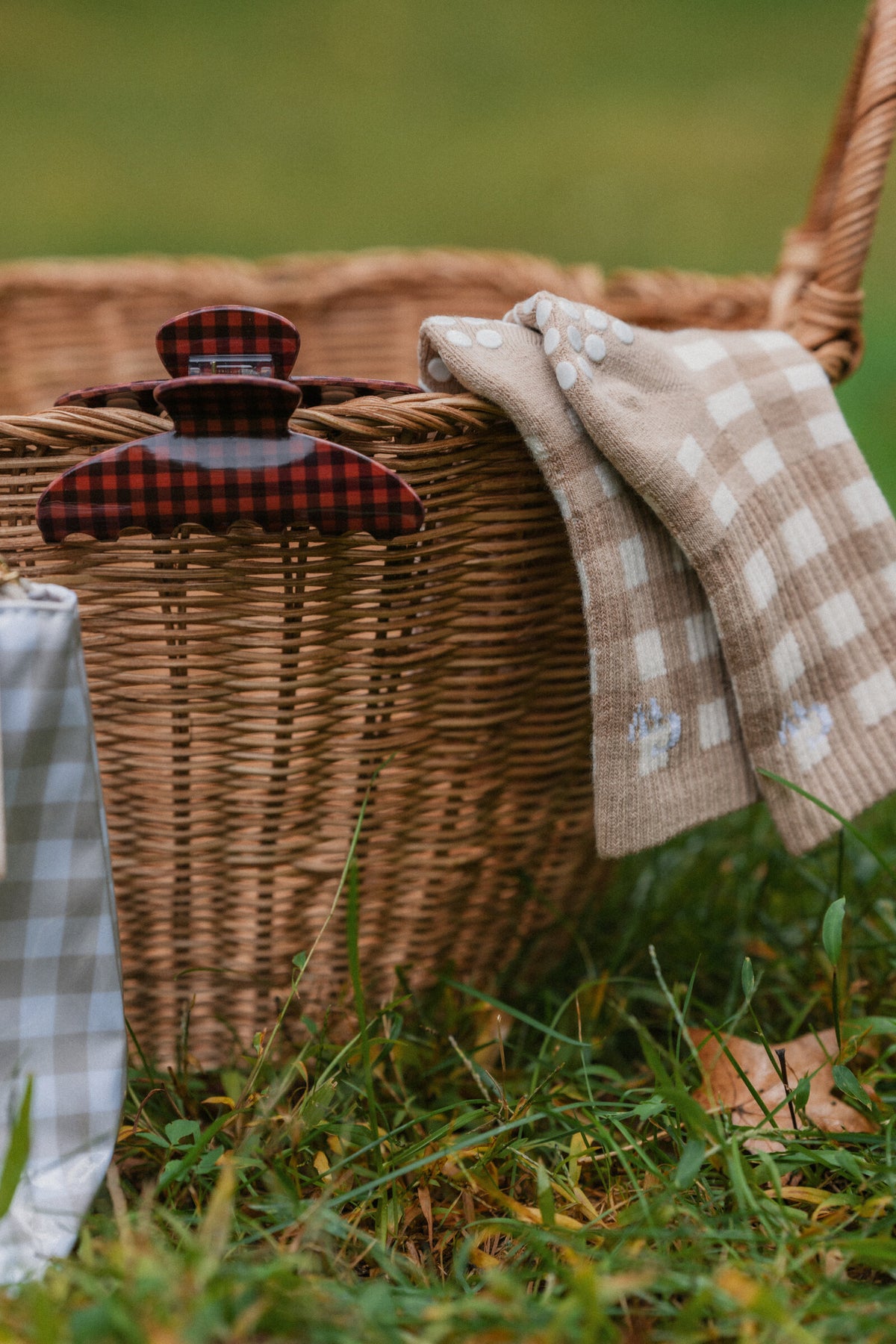 The Clip in Cinnamon gingham on a wicker picnic basket