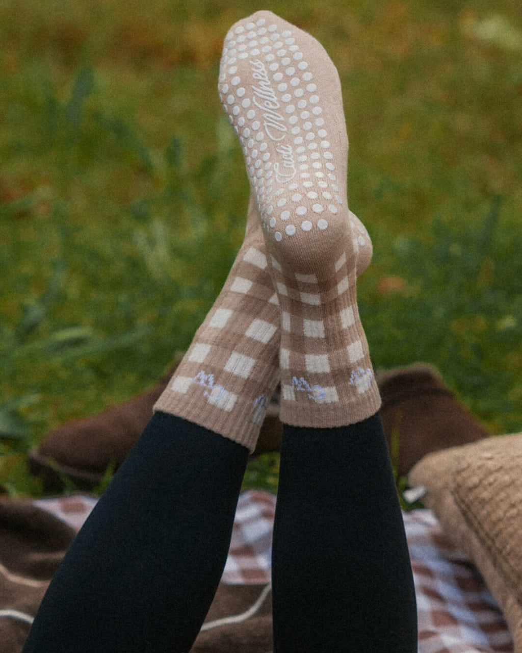 The Grip Socks in Cider gingham worn, showing the grip sole