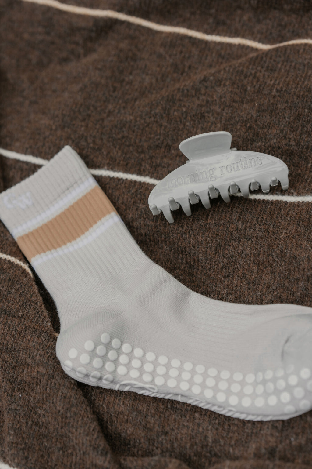 The Grip Socks in Varsity and The Clip in Foggy Morning on a brown blanket