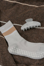 The Grip Socks in Varsity and The Clip in Foggy Morning on a brown blanket